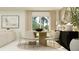 Bright dining room featuring a round wooden table, stylish chairs, modern lighting and neutral tones at 4738 Bold Peacock Bnd, Bartow, FL 33830