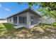 A covered patio sits behind this home, with a fenced-in yard and mature tree adding shade at 5349 Hidden Oaks Dr, Lakeland, FL 33811