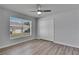 Bright bedroom featuring wood-look floors, neutral walls, and a closet with a fan for added comfort at 5349 Hidden Oaks Dr, Lakeland, FL 33811