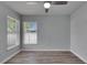 Bedroom featuring wood-look floors, natural light from large windows, and neutral colored walls at 5349 Hidden Oaks Dr, Lakeland, FL 33811