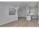 Open dining area with modern chandelier, flowing into the kitchen with white cabinets and countertops at 5349 Hidden Oaks Dr, Lakeland, FL 33811