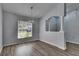 A dining area showcasing wood-look flooring, light fixture, and a sunny window at 5349 Hidden Oaks Dr, Lakeland, FL 33811