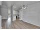 Open floor plan with dining area featuring a modern chandelier and views into the bright kitchen at 5349 Hidden Oaks Dr, Lakeland, FL 33811