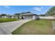 Single-story home boasts a well-maintained lawn, 2 car garage and long driveway at 5349 Hidden Oaks Dr, Lakeland, FL 33811