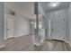 Bright foyer with wood-look flooring, white walls, and a view of the dining room at 5349 Hidden Oaks Dr, Lakeland, FL 33811