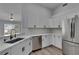 The updated kitchen includes white cabinets, stainless steel appliances, and quartz countertops at 5349 Hidden Oaks Dr, Lakeland, FL 33811