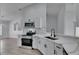 Bright kitchen with white cabinets, stainless steel appliances, and a modern design at 5349 Hidden Oaks Dr, Lakeland, FL 33811
