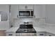 Modern kitchen features stainless steel appliances, white cabinets, and stylish countertops at 5349 Hidden Oaks Dr, Lakeland, FL 33811
