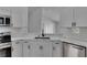Kitchen boasts stainless appliances, white cabinets, subway tile backsplash, and undermount sink at 5349 Hidden Oaks Dr, Lakeland, FL 33811