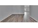 Open living room with wood-look flooring, offering lots of natural light and open space at 5349 Hidden Oaks Dr, Lakeland, FL 33811