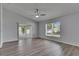 Open living room boasts a fan, sliding door access, and bright windows for plenty of natural light at 5349 Hidden Oaks Dr, Lakeland, FL 33811