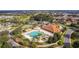 Aerial view of community pool, clubhouse, tennis courts, and well-maintained landscaping at 10367 Addison Shore Way, Oxford, FL 34484