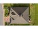 Bird's eye view of home featuring a well maintained roof, a brick driveway, and lush landscaping at 10367 Addison Shore Way, Oxford, FL 34484