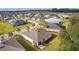 Expansive aerial view of a meticulously planned community with manicured lawns and well-maintained homes at 10367 Addison Shore Way, Oxford, FL 34484
