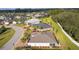 A stunning aerial view showcases the home's backyard with a white fence and patio set at 10367 Addison Shore Way, Oxford, FL 34484