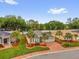 Aerial view showcasing the landscaped front yard and brick-paved driveway of a charming single-Gathering home at 10367 Addison Shore Way, Oxford, FL 34484