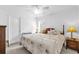 Comfortable bedroom featuring a queen-size bed, ceiling fan, and natural light at 10367 Addison Shore Way, Oxford, FL 34484