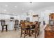 Bright dining area featuring a table for six with modern light fixture at 10367 Addison Shore Way, Oxford, FL 34484