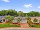 Beautiful single-story home featuring well-manicured landscaping and a paver driveway at 10367 Addison Shore Way, Oxford, FL 34484
