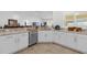 Bright kitchen featuring white cabinets, stainless steel appliances, and granite countertops at 10367 Addison Shore Way, Oxford, FL 34484