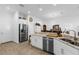 Bright open kitchen with white cabinets, stainless appliances and a counter overlooking the dining area at 10367 Addison Shore Way, Oxford, FL 34484