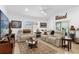 Bright living room with neutral decor, comfortable seating, and a decorative ceiling fan at 10367 Addison Shore Way, Oxford, FL 34484
