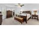 Spacious main bedroom with large windows, dark wood furniture, and neutral carpet at 10367 Addison Shore Way, Oxford, FL 34484