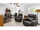 Well-appointed home office with comfortable seating, built-in shelving, and natural light at 10367 Addison Shore Way, Oxford, FL 34484