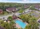 Aerial view of community featuring a swimming pool, tennis courts, lush landscaping, and well-maintained townhomes at 6109 Apollos Corner Way, Orlando, FL 32829