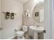 Charming powder room features a pedestal sink, neutral walls, and decorative accents at 6109 Apollos Corner Way, Orlando, FL 32829