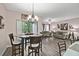 Cozy dining area with modern lighting, furniture, and an open view of the living space at 6109 Apollos Corner Way, Orlando, FL 32829