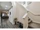 Welcoming entryway featuring a staircase, shoe rack, and views of the living area at 6109 Apollos Corner Way, Orlando, FL 32829