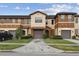 Charming townhome featuring a two-car garage, neutral stucco, and a well-manicured lawn at 6109 Apollos Corner Way, Orlando, FL 32829