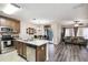Open-concept kitchen and living area with ample natural light and modern vinyl flooring at 6109 Apollos Corner Way, Orlando, FL 32829