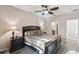 Spacious main bedroom featuring a large bed, stylish decor, and access to the en-suite bathroom at 6109 Apollos Corner Way, Orlando, FL 32829