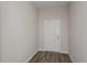 Entryway with wood-look flooring, neutral paint, and a classic white door at 1022 Foreshore Ln, Haines City, FL 33844