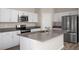 This spacious kitchen features stainless steel appliances, white cabinets, and an island with a sink at 1022 Foreshore Ln, Haines City, FL 33844