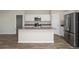 Open concept kitchen features stainless steel appliances, white cabinets, and an island with a sink at 1022 Foreshore Ln, Haines City, FL 33844