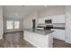 Bright kitchen features stainless steel appliances, gray countertops, white cabinets, and an island at 1022 Foreshore Ln, Haines City, FL 33844