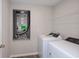 Laundry room with washer and dryer, HVAC equipment, and wire rack shelf at 1022 Foreshore Ln, Haines City, FL 33844