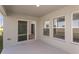 Covered patio with sliding glass doors, windows, and view of the landscaped yard at 1022 Foreshore Ln, Haines City, FL 33844