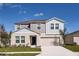 Charming two-story home featuring a two-car garage, a well-manicured lawn, and beautiful curb appeal at 1030 Foreshore Ln, Haines City, FL 33844