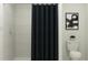 The bathroom showcases a shower with sleek tile and a modern dark-colored shower curtain at 1313 Acorn Meadow Loop, Eustis, FL 32726