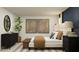 Bright bedroom featuring a modern dresser, a large ficus, and stylish neutral artwork at 1313 Acorn Meadow Loop, Eustis, FL 32726