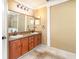 A well-lit bathroom has double sinks with vanity and tile floors at 1300 Holly Glen Run, Apopka, FL 32703