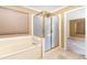 Spacious bathtub and gold-trimmed shower in the main bathroom at 1300 Holly Glen Run, Apopka, FL 32703