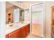 Bathroom featuring a double sink vanity with cabinet storage and a connecting door to a bedroom at 1300 Holly Glen Run, Apopka, FL 32703