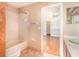 Bathroom showcasing a shower-tub combination and a view of an adjacent bedroom at 1300 Holly Glen Run, Apopka, FL 32703