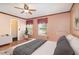 Cozy bedroom with wood floors, two windows, and decor accents at 1300 Holly Glen Run, Apopka, FL 32703