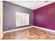 Simple bedroom with tiled floor and bright window at 1300 Holly Glen Run, Apopka, FL 32703
